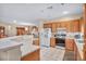 Open kitchen view with a breakfast bar, light wood cabinetry, and durable tile flooring at 2571 Thatcher Ave, Henderson, NV 89052
