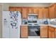 Practical kitchen with wood cabinets, stainless steel appliances, and ample countertop space at 2571 Thatcher Ave, Henderson, NV 89052