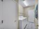 Laundry room with tile floors, wire shelving, and white appliances at 2571 Thatcher Ave, Henderson, NV 89052