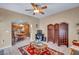 Living room with tile floor, ceiling fan, and an open view into the dining area at 2571 Thatcher Ave, Henderson, NV 89052