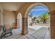 Covered patio with multiple archways providing a charming view of the manicured yard at 2571 Thatcher Ave, Henderson, NV 89052