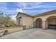 Charming patio featuring arched openings, desert landscaping, and outdoor seating, great for relaxing and entertaining at 2571 Thatcher Ave, Henderson, NV 89052