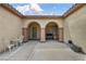 Charming patio with arched openings, neutral colors, and seating area, perfect for relaxing and entertaining guests at 2571 Thatcher Ave, Henderson, NV 89052