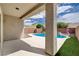 Relaxing backyard with a private pool, manicured landscaping, and a covered patio area at 2621 Ground Robin Dr, North Las Vegas, NV 89084
