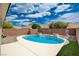 Beautiful backyard with a sparkling pool, lush turf, and privacy wall, perfect for outdoor entertaining at 2621 Ground Robin Dr, North Las Vegas, NV 89084