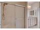 Bathroom featuring glass shower, chrome hardware, double sinks with granite counters and tile flooring at 2621 Ground Robin Dr, North Las Vegas, NV 89084