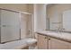Bathroom featuring a tub/shower combo, granite counters, chrome hardware, and tile flooring at 2621 Ground Robin Dr, North Las Vegas, NV 89084
