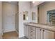 Spacious bathroom featuring double sinks, granite counters, shower with glass doors and walk-in closet at 2621 Ground Robin Dr, North Las Vegas, NV 89084