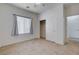 Empty bedroom with tile flooring, bright lighting, a window with blinds, and closet space at 2621 Ground Robin Dr, North Las Vegas, NV 89084