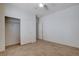 Empty bedroom with tile flooring, bright lighting, closet, and neutral wall color at 2621 Ground Robin Dr, North Las Vegas, NV 89084