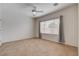 Bright, minimalist bedroom featuring a large window and tile flooring at 2621 Ground Robin Dr, North Las Vegas, NV 89084