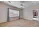 Simple, well-lit bedroom with a large window and connecting door to an adjacent room at 2621 Ground Robin Dr, North Las Vegas, NV 89084