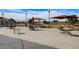 Inviting community patio with tables, chairs, and shaded umbrellas, ideal for outdoor gatherings at 2621 Ground Robin Dr, North Las Vegas, NV 89084