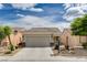 Charming single-story home featuring a two-car garage and desert landscaping with rock accents at 2621 Ground Robin Dr, North Las Vegas, NV 89084