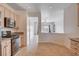 View of kitchen with stainless steel stove, and view to living room with access to pool at 2621 Ground Robin Dr, North Las Vegas, NV 89084