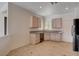 Kitchen featuring light wood cabinets and granite countertops, providing a clean and stylish cooking space at 2621 Ground Robin Dr, North Las Vegas, NV 89084