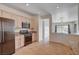 Modern kitchen layout with stainless steel appliances overlooking the living area and pool at 2621 Ground Robin Dr, North Las Vegas, NV 89084