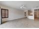 Open-concept living area featuring tile flooring and a ceiling fan for added comfort at 2621 Ground Robin Dr, North Las Vegas, NV 89084