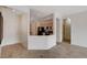 Open-concept living room showcasing tile flooring, and a partial view into the kitchen area at 2621 Ground Robin Dr, North Las Vegas, NV 89084
