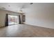 Bright and airy living room with tile flooring and sliding glass doors leading to the pool area at 2621 Ground Robin Dr, North Las Vegas, NV 89084