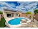 Inviting backyard with solar panels, showcasing a sparkling pool with planters at 2621 Ground Robin Dr, North Las Vegas, NV 89084