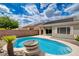 Backyard oasis with solar panels, features a sparkling pool, patio, and privacy wall at 2621 Ground Robin Dr, North Las Vegas, NV 89084