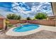 Inviting backyard featuring a sparkling pool, custom planters, and beautiful desert landscaping at 2621 Ground Robin Dr, North Las Vegas, NV 89084