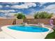 Private backyard showcasing a sparkling pool surrounded by desert landscaping and a brick privacy wall at 2621 Ground Robin Dr, North Las Vegas, NV 89084