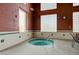 Cozy hot tub with textured brick wall and large glass block window at 2621 Ground Robin Dr, North Las Vegas, NV 89084