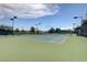 Community tennis court featuring an enclosed fence with basketball hoops, offering a great recreational option at 2621 Ground Robin Dr, North Las Vegas, NV 89084