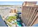 Aerial view of luxury resort pool, lush palms, and high-rise tower, perfect for relaxation and recreation at 2700 Las Vegas Blvd # 2303, Las Vegas, NV 89109