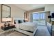 Bedroom features a luxurious king bed, stylish decor, and a large window with city views at 2700 Las Vegas Blvd # 2303, Las Vegas, NV 89109