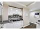 Modern kitchen with gray counter tops, sleek white cabinets and stainless steel appliances at 2700 Las Vegas Blvd # 2303, Las Vegas, NV 89109
