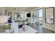 Bright living room with white sofa, glass table, and city view through windows at 2700 Las Vegas Blvd # 2303, Las Vegas, NV 89109
