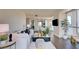 Bright living room with white sofa, glass table, and city view through windows at 2700 Las Vegas Blvd # 2303, Las Vegas, NV 89109