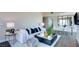 Bright living room with white sofa, glass table, and city view through windows at 2700 Las Vegas Blvd # 2303, Las Vegas, NV 89109