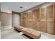Locker room featuring wooden lockers, tile flooring, and benches creating a functional and organized space at 2700 Las Vegas Blvd # 2303, Las Vegas, NV 89109