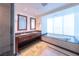 Luxurious bathroom featuring double sinks, granite countertops and a soaking tub at 2700 Las Vegas Blvd # 2809, Las Vegas, NV 89109