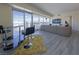 Open living space with panoramic city views, a plush sofa and a modern bar area at 2700 Las Vegas Blvd # 2809, Las Vegas, NV 89109