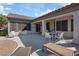 Spacious backyard with a covered patio, seating area, and desert landscaping at 2862 Sapphire Desert Dr, Henderson, NV 89052