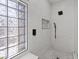 Luxurious walk-in shower features designer tile, bench, and black hardware at 2862 Sapphire Desert Dr, Henderson, NV 89052