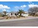 Inviting single-story home with a two-car garage, desert landscaping, and mature palm trees at 2862 Sapphire Desert Dr, Henderson, NV 89052