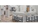The kitchen has a breakfast bar, white cabinets and stainless steel appliances at 2862 Sapphire Desert Dr, Henderson, NV 89052