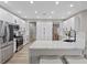 Modern kitchen features white cabinets, stainless steel appliances, and a breakfast bar at 2862 Sapphire Desert Dr, Henderson, NV 89052