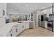 Open kitchen featuring stainless appliances, white cabinetry, and views of the living area at 2862 Sapphire Desert Dr, Henderson, NV 89052