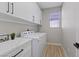 Convenient laundry room with modern washer, dryer, and ample storage at 2862 Sapphire Desert Dr, Henderson, NV 89052