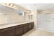 Bathroom features double sinks with granite counters and glass-enclosed shower at 3049 Historic Horizon Ave, Henderson, NV 89044