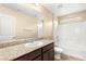 Bathroom featuring granite countertop vanity, bathtub with shower, and neutral tiling at 3049 Historic Horizon Ave, Henderson, NV 89044