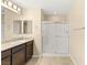 Bright bathroom with double vanity, granite countertops, and a glass shower at 3049 Historic Horizon Ave, Henderson, NV 89044