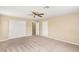 Spacious carpeted bedroom with double closets and a ceiling fan at 3049 Historic Horizon Ave, Henderson, NV 89044